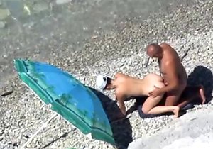 Doggy style fuck sesh occurs on a nudist beach